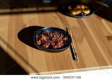 Asian Food Homemade Chinese General Tsos Chicken With Sesame Seeds Served With Chopsticks.