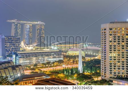 Singapore Hdb Building Complex And Downtown Skylines Illuminated In Blue Hour