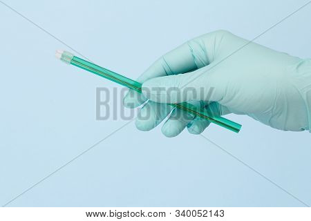 Dentist's Hand In Glove With A Saliva Ejector.