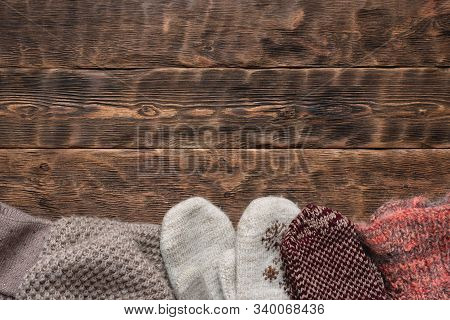 Winter Warm Clothes On Brown Wooden Table Background.