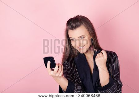 Girl In Coat Makes Brush Makeup Looks In The Mirror