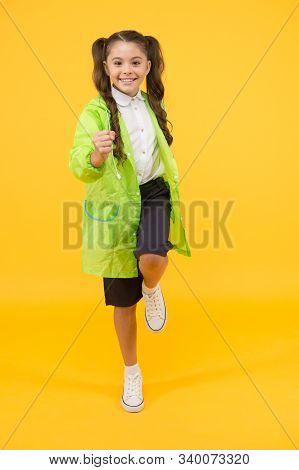 Enjoy Autumn Rain. Amazing Discounts. Small Girl Have Fun In Raincoat. Active Schoolgirl Waterproof 