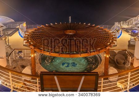 Back Balcony Of Diamond Princess Cruise Ship With Service Bar And Swimming Pool At Night.