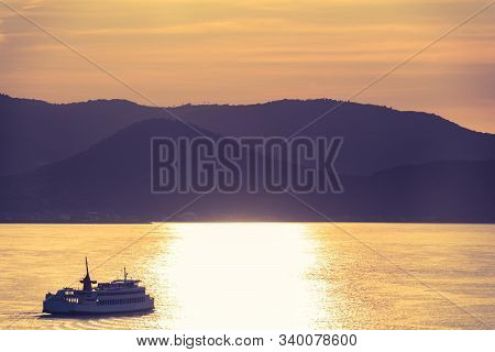Boat Ferry Is Travel Along Takamatsu Islands In Japan, With Golden Sunset Reflection Sky For Vacatio