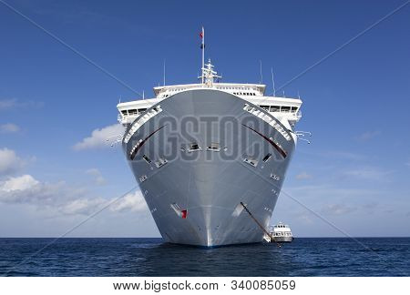 The View In Front Of A Drifting Cruise Liner And A Tender Boat Taking Tourists To Grand Cayman Islan