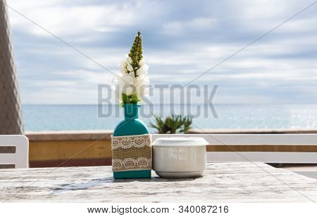 Warehouse On The Open Air. Chairs And Tables Outside On The Summer Sun Weather. Vase With The Flower