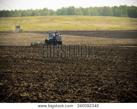 Tractors Plow Plowland On An Autumn Clear Day