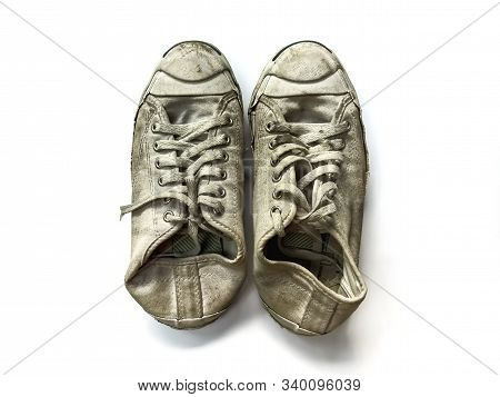 The White Sneakers Are Very Dirty On White Background.