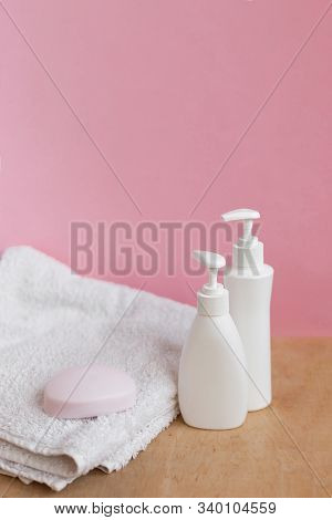 Blank Plastic Bottles And Bar Of Soap On Shower Towl In Pastel Modern Interior. Hygiene Cosmetic Con