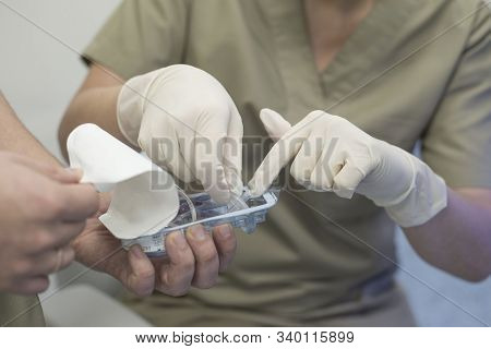 Close-up Of The Hands Of An Ophthalmologist Surgeon With The Help Of The Hands Of An Assistant Surge