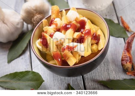 Canadian poutine, fried potato chips with cheese and gravy or sauce