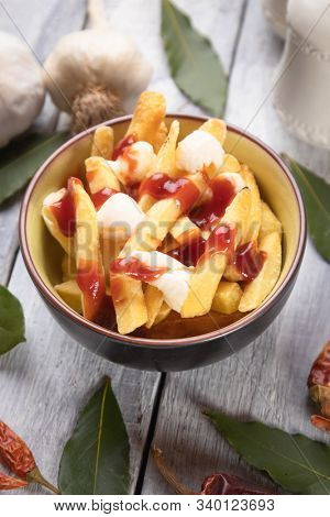 Canadian poutine, fried potato chips with cheese and gravy or sauce