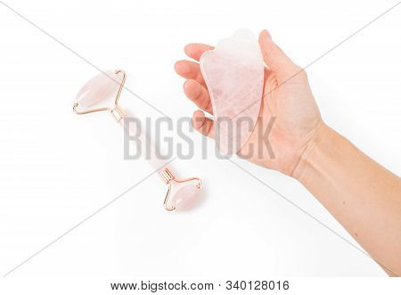 Guasha Massage. Woman's Hand Holding Jade Roller Stone For Face Massage.