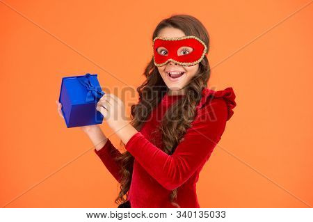 Winter Event And Entertainment. Secret Santa Gift Concept. Kid Wear Eye Mask. Girl In Mask Orange Ba