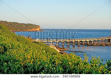 Famous Bare Island And Its Wooden Footbridge In Sunset Light, Sydney Australia. It Is A Former Milit