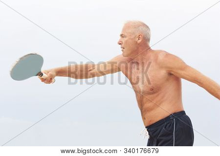 Adult Male Playing Matkot On The Beach