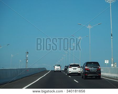 Denpasar, Indonesia - August 23, 2019: Vehicles Running On Bali Mandara Toll Road Which Carried By A