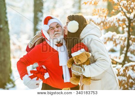 Beauty Girl Kiss Santa. Santa Claus With Girl. Winter Landscape Of Forest And Snow With Santa Claus