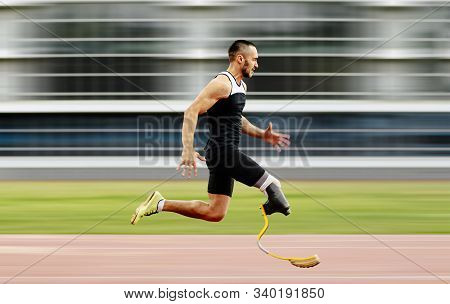 Disabled Athlete Amputee Leg Running With Prosthetic On Background Of Motion Blur