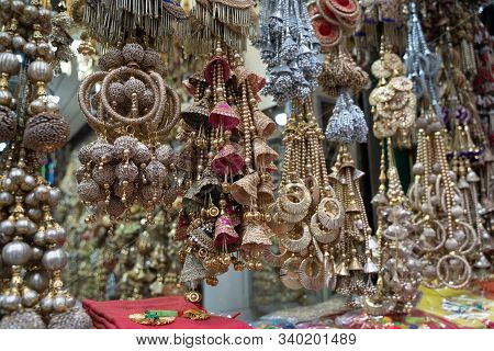 Colorful Metallic Decorations On Display For Sale In Chandi Chowk Old Delhi. These Flowers, Beads An