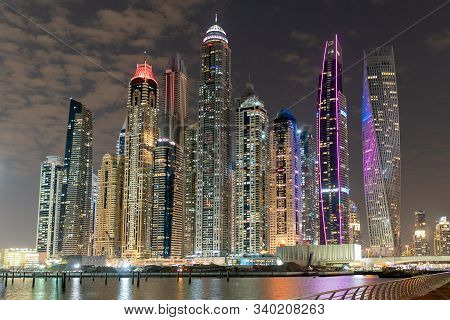 Dubai Skyline At Night With Lights On The Water And Luxirious Skyscrapers Of Uae, Travel Destination