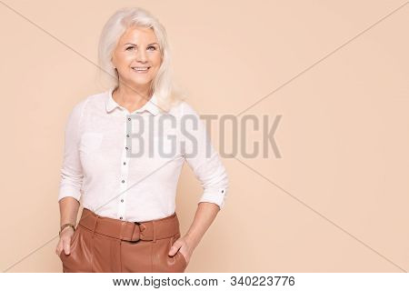 Smiling Senior Lady In Fashionable Clothes.