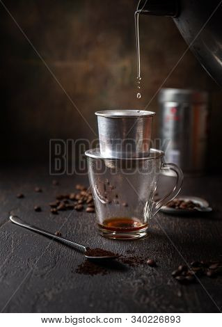 Preparation Of Vietnamese Coffe With Aluminum Cofe Filer On Dark Background