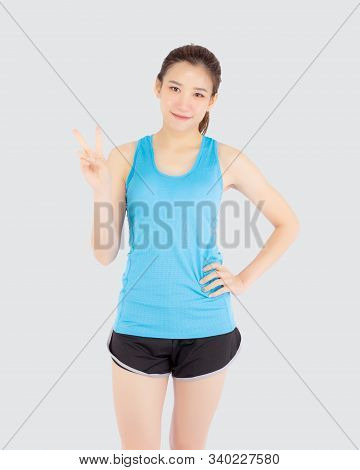 Beautiful Portrait Young Asian Woman In Sport Clothes With Satisfied And Confident Gesture Finger V