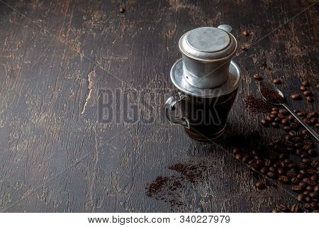 Preparation Of Vietnamese Coffe With Aluminum Cofe Filer On Dark Background