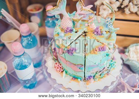 A Cut Of Cake. Mermaid Candy Bar.  A Beautiful Cake Decorated With Mermaid Tails.