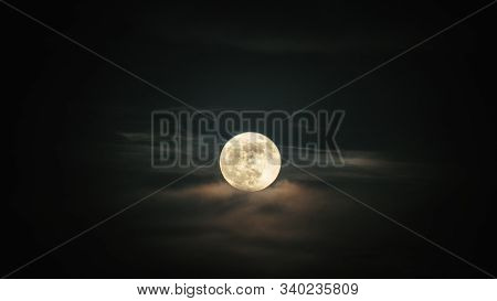 Full Moon Setting On The Clouds In Iran