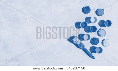 Blue Color Background. Colorful Glass Beads Pattern. Paints In Round Jars And Brush On A Gray Concre