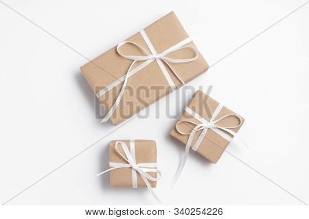 Brown Gift Box Tied With White Ribbon On Clear Background, Copy Space, Eco-friendly Present Concept