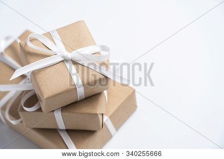 Brown Gift Box Tied With White Ribbon On Clear Background, Copy Space, Eco-friendly Present Concept