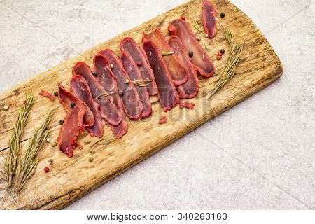 Basturma, Dried Tenderloin Of Beef Meat, Jerky, Thinly Sliced. Dry Rosemary, Pepper Mix On Vintage W