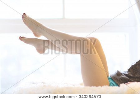 Woman Bare Legs With Pedicure Close Up Photo On Window Background