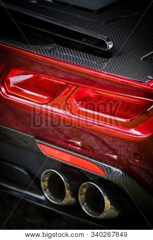Close Up Vertical Image Of The Led Tail Lights And Exhaust Pipes Of A New Sport Super Car.