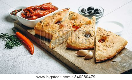 Traditional Italian Focaccia With Tomatoes, Olives And Rosemary - Homemade Flat Bread Focaccia.