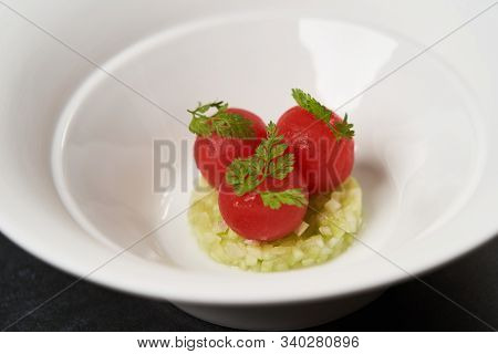 Fresh Peeled Chili Tomatoes And Minced Cucumbers On Dark Background