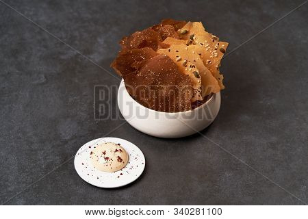 Cereal Chips With Seeds And Kimchi Mayonnaise Sauce On Dark Background