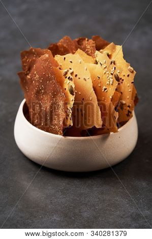 Cereal Chips With Seeds And Kimchi Mayonnaise Sauce On Dark Background