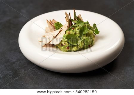 Guacamole With Pita Chips On White Plate. Chef's Signature Dish