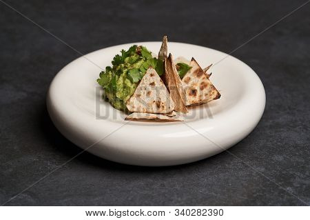 Guacamole With Pita Chips On White Plate. Chef's Signature Dish