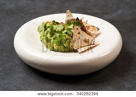 Guacamole With Pita Chips On White Plate. Chef's Signature Dish