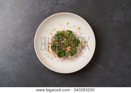 Fresh Beef Tartare Dish With Fresh Vegetables In White Plate