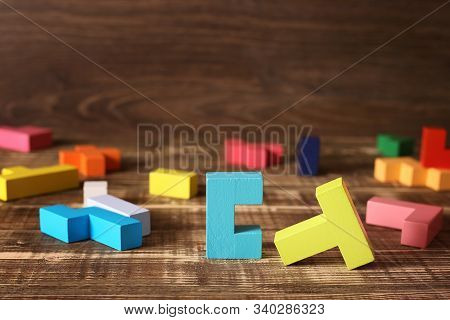 Simple Solutions To Complex Problems. Strategy In Business. Wooden Tetris Cubes On A Dark Background