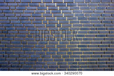 Full Frame Abstract Dark Blue Brick Wall With Golden Gaps