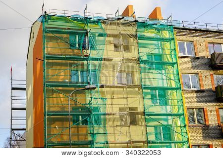 Scaffolding Arround The House To Install Thermal Insulation Of The Apartment Building Facade