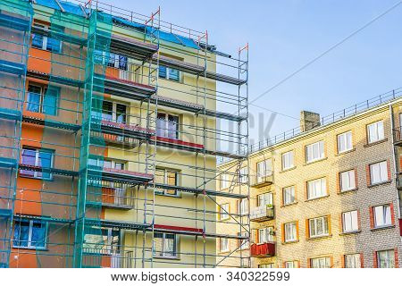 Scaffolding Arround The House To Install Thermal Insulation Of The Apartment Building Facade