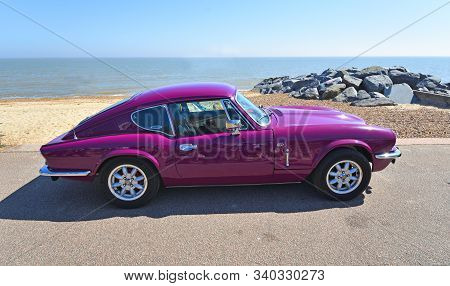 Felixstowe, Suffolk, England - May 06, 2018:  Classic Purple Triumph Gt6 Parked On Seafront Promenad